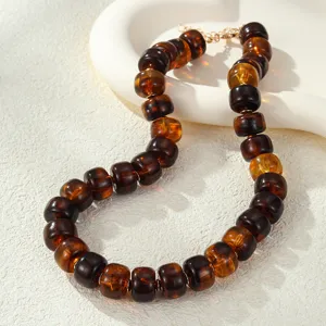 Exquisite acrylic resin barrel bead necklace detail, vintage brown choker jewelry accessory.