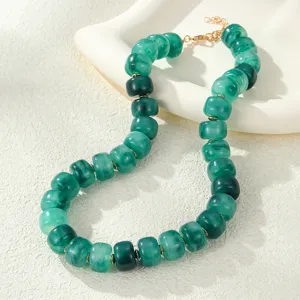 Green resin beaded necklace detail shot, showcasing jelly color texture and metal clasp finish.
