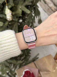 Detail shot of the pink striped wavy watch strap worn on wrist, showing fine texture and style.