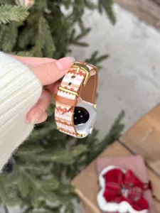 Close-up of knitted striped leather watch strap with gold buckle for Apple Watch detail view.