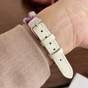 Cinturino per orologio in pelle bianca con perle di cristallo e fibbia, vista dettagliata.