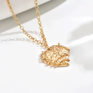 Close-up detail of the vintage hammered heart pendant necklace, textured gold-link chain design.