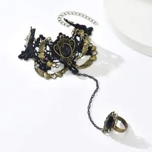 Vintage gothic black lace finger ring bracelet with bronze alloy charms and black gemstone.