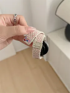 Woven smartwatch replacement strap with metal buckle and cute sweet charm detail stylish.