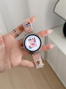 Pink woven smartwatch strap with cute bear charm and metal buckle, replacement band for smartwatches.