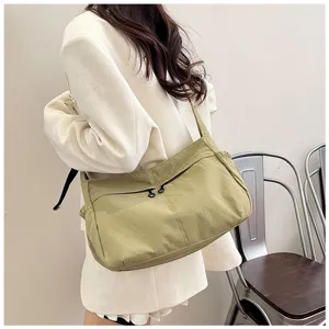 Detail shot of casual nylon crossbody shoulder bag, large capacity work style design for daily commute.