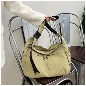 Detail shot of casual cargo style nylon shoulder bag, large capacity, khaki crossbody design.