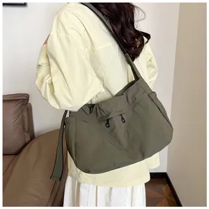 Nylon shoulder bag detail view, casual crossbody design with drawstring and strap.