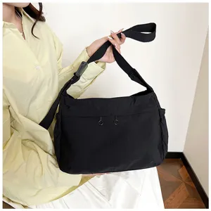 Black nylon crossbody bag, casual womens shoulder bag with adjustable strap for daily use.