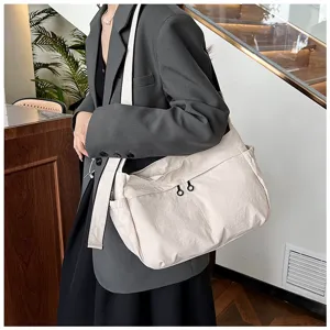 Casual utility nylon crossbody bag worn by model, showing large capacity and daily commuting style.