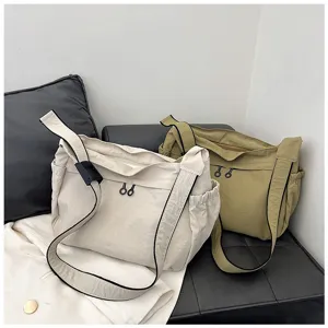 Detail view of casual nylon crossbody bag, large capacity utility shoulder bag for daily commute.