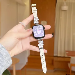 Metal flower leather watch strap detail view, elegant floral charm design for smart watch.