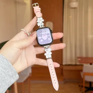 Pink leather metal flower watch band compatible with Apple Watch, stylish rhinestone charm strap.