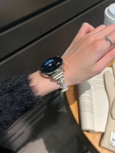 Gros plan détaillé d'un élégant bracelet de montre en métal avec perles et étoiles.