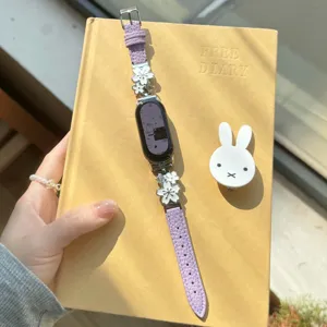Close-up detail of luxury metal flower leather smartwatch replacement strap in elegant purple.