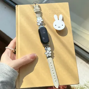 White floral leather smart watch strap band with metal charms for stylish daily wear.