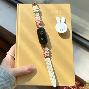 Metal flower leather smart watch strap replacement band with sparkling rhinestones for daily wear.