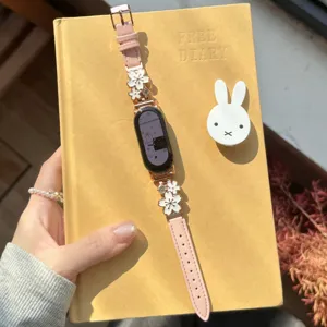 Metal flower leather smart watch band replacement with pink strap and sparkling crystal charms.