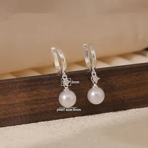 Detailed close-up of French style silver pearl hoop earrings with diamond and 9mm pearl drop.