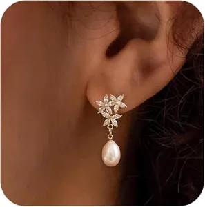 Close-up detail view of elegant French style pearl and zircon flower stud earrings.