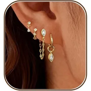 Stunning multi-piece gold plated cubic zirconia earring set worn on ear for women chic style.