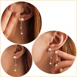 Squisiti orecchini lunghi con fiori bianchi delicati, zirconi brillanti ed eleganti perle pendenti.