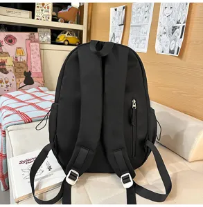 Zaino nero minimalista, grande capacità da viaggio e scuola casual per donne e studentesse.