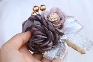 Korean style wedding boutonniere detail close-up showing fabric flower and silver bow.