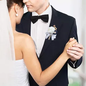 Exquisite wedding groom boutonniere detail shot, artificial flower corsage lapel pin.