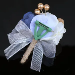 Detailed back view of Korean wedding corsage with silver bow and blue white fabric flowers.