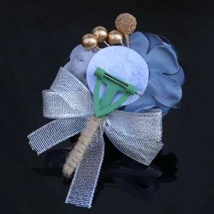 Wedding boutonniere back design detail showing secure pin clasp and silver glitter bow.
