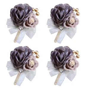 Korean wedding corsage detail showing dark grey fabric rose, silver ribbon and gold bead accents.