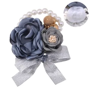 Exquisite artificial flower wrist corsage with pearls, silver ribbon and elegant fabric roses.