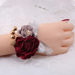 Detail view of Korean style wedding wrist corsage with fabric roses and silver ribbon.
