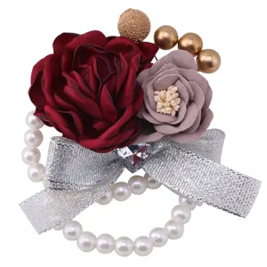 Korean style wedding wrist flower corsage with artificial roses, pearls and silver bow.