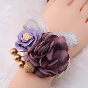 Elegant Korean style wedding wrist flower with purple fabric roses and silver ribbon.