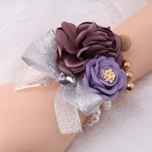 Korean style artificial flower wrist corsage detail showcasing purple fabric roses and silver ribbon.
