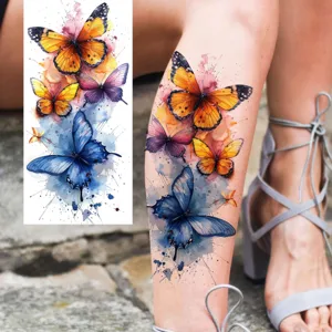 Watercolor butterfly temporary tattoo sticker for leg and arm, realistic floral body art design.