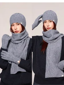 Grey winter knitted hat scarf gloves set detail, cozy cable knit texture, cold weather accessory.