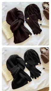 Detailed view of winter cable-knit cozy scarf, beanie hat, and gloves three-piece set.
