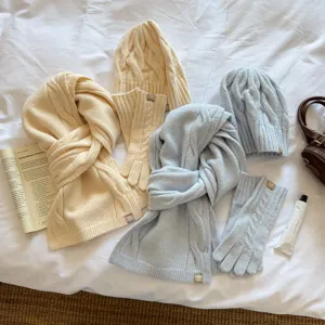 Cozy winter three-piece knitted set with scarf beanie and gloves for warm daily wear.
