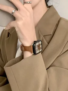 Slim brown leather strap detail for Apple Watch, elegant replacement wristband for smart watch.