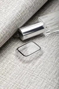 Detailed view of a clear smartwatch protective case with black frame on textured background.