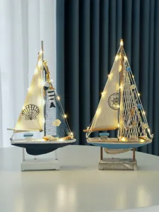 Nautical sailboat decor detail view, wooden craft boat with warm LED fairy lights for home.