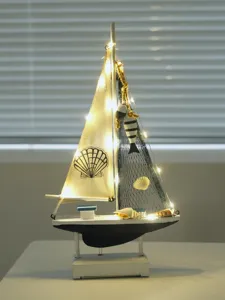 Detailed nautical wooden sailboat model with warm LED lights, coastal home decor and gift.