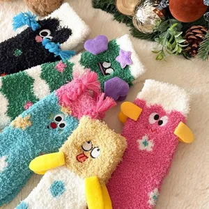 Close-up detail of fluffy plush coral fleece funny cartoon embroidered socks with cute 3D elements.