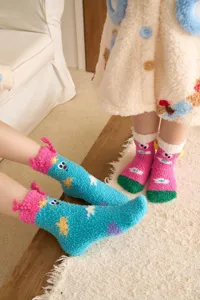Cozy thick coral fleece winter socks with cute 3D cartoon plush design for warm home wear.