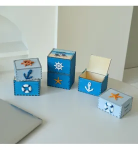 Detailed view of handmade Mediterranean wooden storage boxes with cute nautical beach decorations.