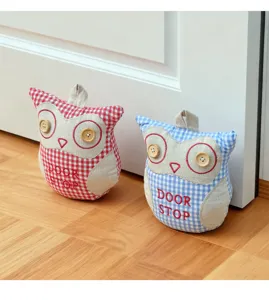 Detailed view of cute owl fabric door stop with checkered pattern, wooden buttons and sturdy build.