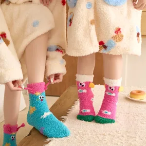 Detailed view of cute thick fuzzy coral fleece cartoon embroidered cozy socks for cold winter days.